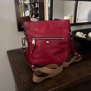 B. Makowsky red leather crossbody bag with a leopard lining.